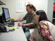 Peer mentors Timothy Tipton and Kodi Findlay share a laugh as they work in their office at Clark College in Vancouver. Tipton was released from Larch Corrections Center this summer. While he was at Larch, he was certified as a GED teaching assistant and tutored other inmates.