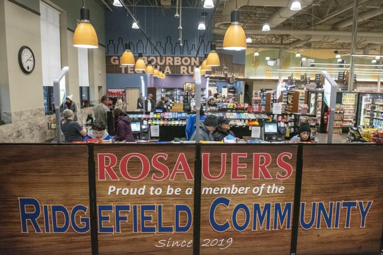 Shoppers check out at the new Ridgefield Rosauers, which opened on Saturday.