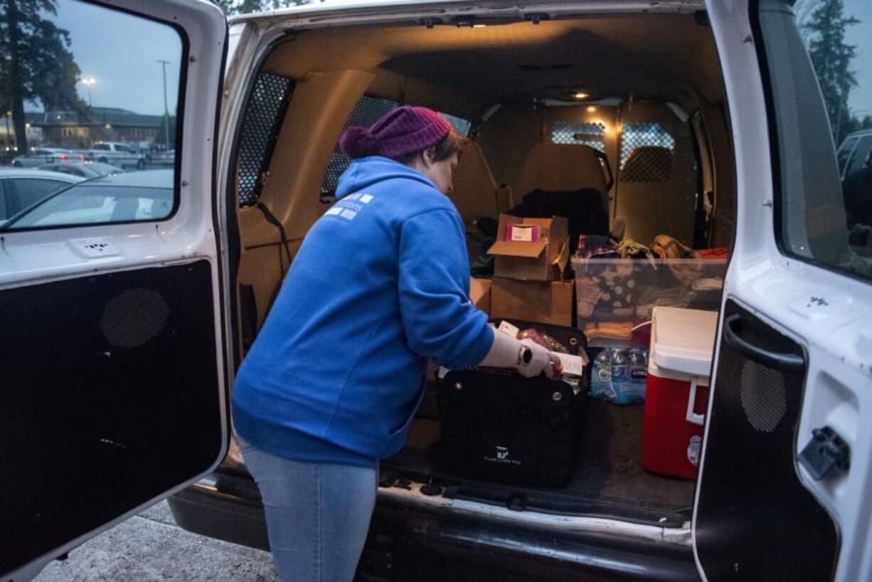 Lifeline counselor Tiffany Kostrba, left, and Lifeline admissions coordinator Cindy Malone, right, are pictured before they leave for their shift in the Sobering Urgent Response Vehicle at Lifeline Connections&#039; office in Vancouver. Kostrba typically goes out in the van five times weekly and Malone tries to go out two to three times weekly. At top, Lifeline Connections heads out in the Sobering Urgent Response Vehicle, a 15-passenger van that was donated by the Clark County Sheriff&#039;s Office.