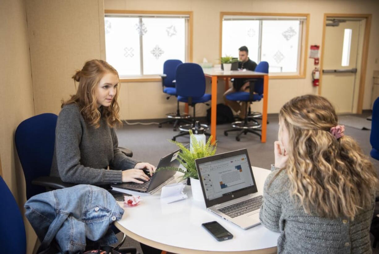 Ridgefield High School seniors Emma Haynie, left, and Hailee Gruber work on a presentation together during Ridgefield High School&#039;s Center for Advanced Professional Studies program. Both are in the business, marketing and entrepreneurship strand program. Students can also enroll in the engineering or health sciences strands.