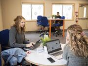 Ridgefield High School seniors Emma Haynie, left, and Hailee Gruber work on a presentation together during Ridgefield High School&#039;s Center for Advanced Professional Studies program. Both are in the business, marketing and entrepreneurship strand program. Students can also enroll in the engineering or health sciences strands.