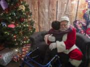 Wyatt Lovato, 6, of Vancouver, shares a quiet moment with Santa Claus, also known as Bill Kerner, on the Legacy Salmon Creek Medical Center campus. The hospital offered children with special needs an opportunity to spend one-on-one time with Santa without the frantic noise and crowds of the holiday season.