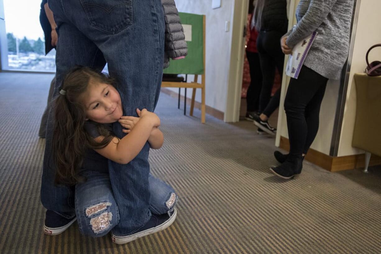 Charlotte Cavazos, 4, of Ridgefield spends a shy moment with her dad, Josh Cavazos, before visiting Santa at Legacy Salmon Creek Medical Center. Cavazos said his daughter was excited to see Santa.