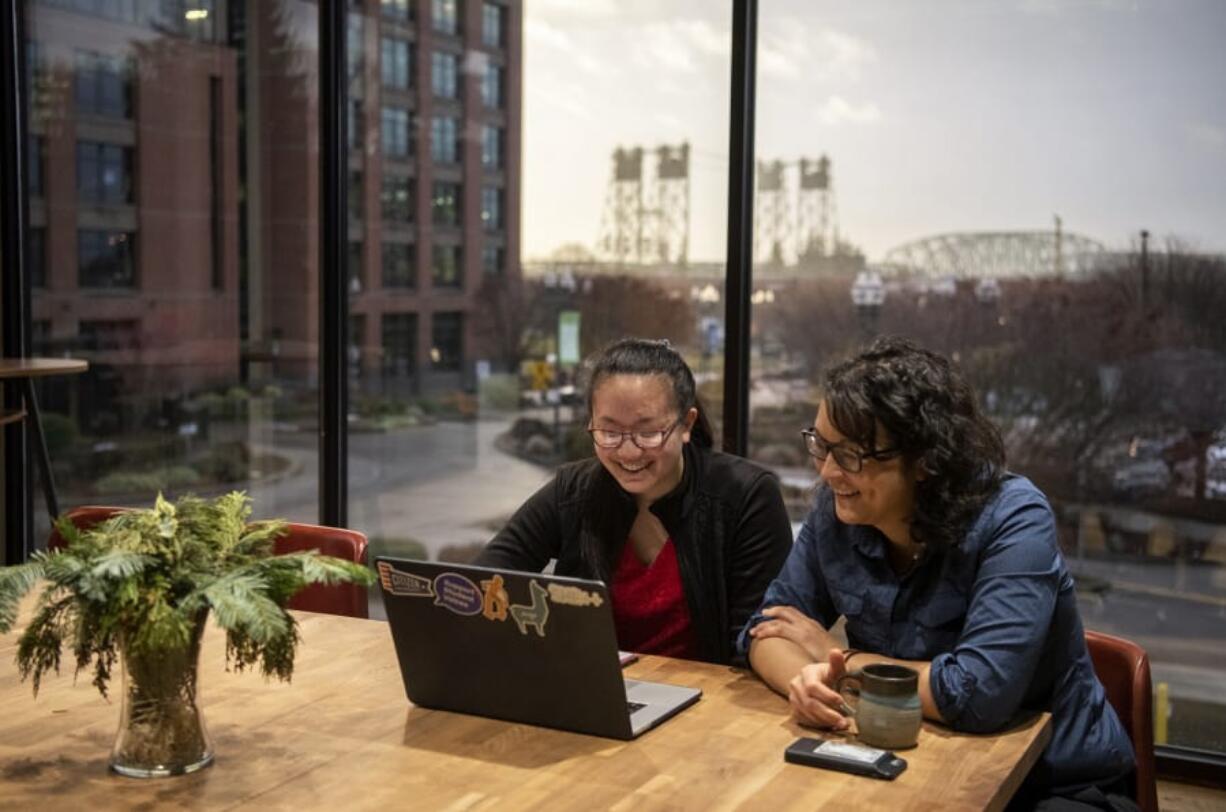 Sixteen-year-old Ashley Lin, left, of Vancouver meets Thursday morning with one of her mentors, architect Melissa Guarin at LSW. Ashley founded Project Exchange, a nonprofit organization providing virtual exchange programs for students who might not be able to afford a more traditional study-abroad program. During this meeting, Guarin helped Ashley with ideas for virtual field trip sessions.