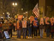 Demonstrators gather to support the impeachment of President Donald Trump during a rally at Esther Short Park on Tuesday evening. Participants kicked off the event with music and chants before hearing from speakers and waving signs along Sixth and Columbia streets.