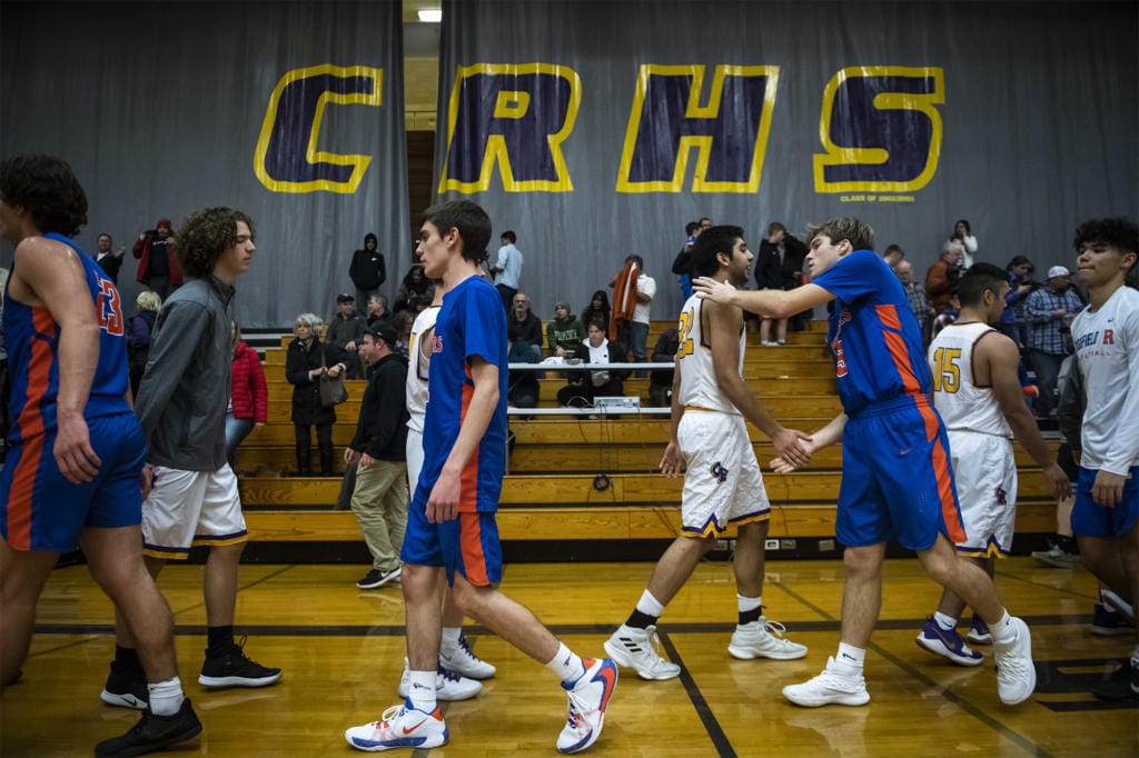 Ridgefield and Columbia River players shake hands following Columbia River’s victory at Columbia River High School on Thursday night, Dec. 19, 2019.