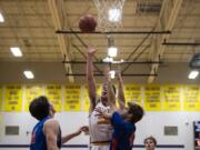 Columbia RiverCfUs Michael Foust completes a layup during a game against Ridgfield at Columbia River High School on Thursday night, Dec. 19, 2019.