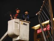 Rabbi Shmulik Greenberg lights a menorah to mark the first night of Hanukkah at Esther Short Park.