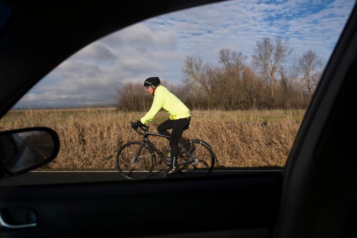 The Vancouver Bicycle Club recently held a group ride to raise awareness of a new state law that adds protections for cyclists and pedestrians sharing travel lanes with cars. Drivers are now required to slow down and give at least three feet of space, if not a whole lane, when passing bikes and walkers in the road. (Samuel Wilson/for The Columbian )