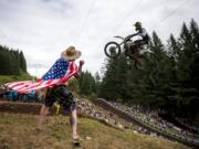 Matt Minor of Salem, Ore., cheers on the riders as they glide over a jump at the top of the course during the Washougal National Lucas Oil Pro Motocross at the Washougal MX Park on Saturday afternoon, July 27, 2019.