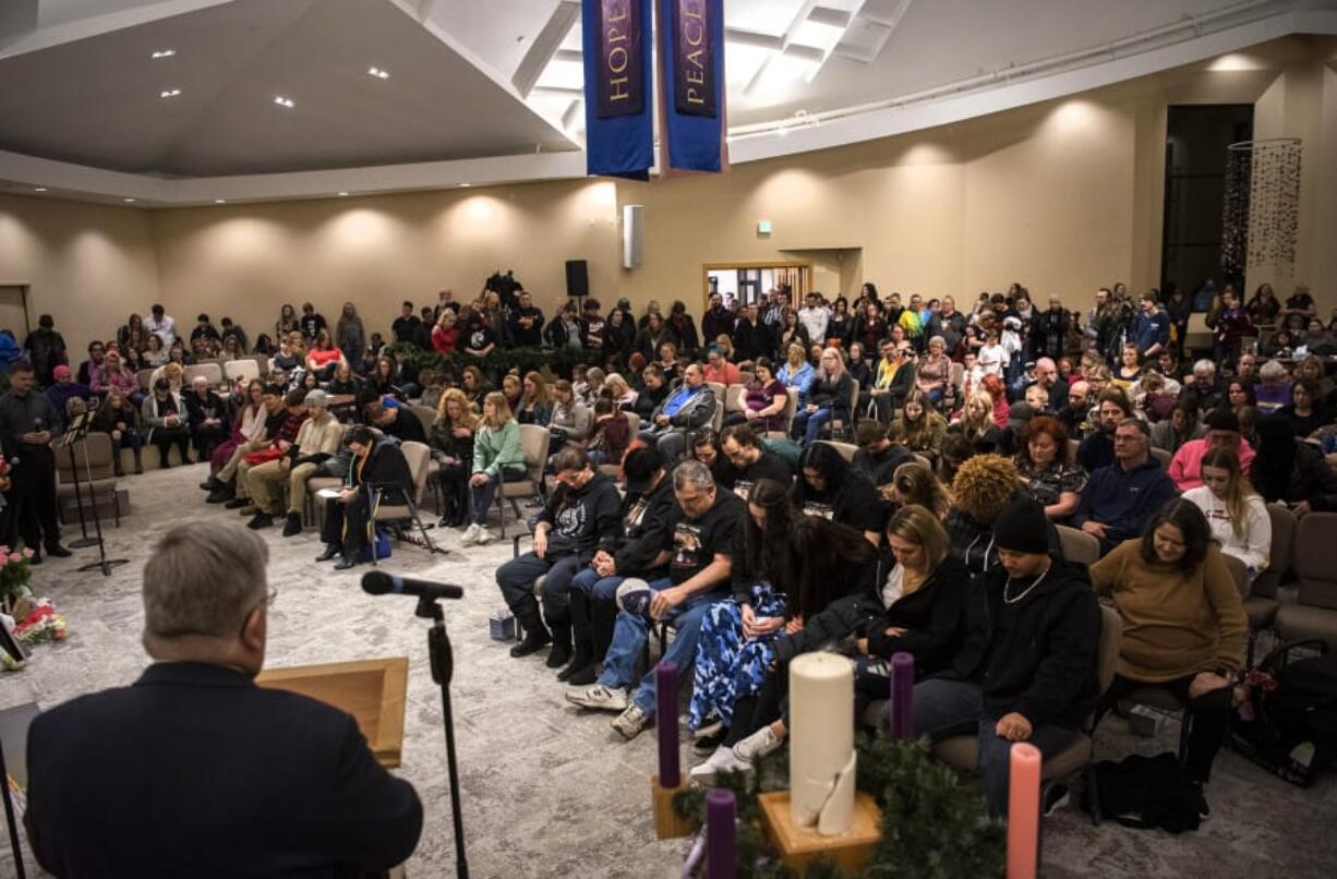 Rev. Ken Kerr, pastor of Metropolitan Community Church of Portland, leads a prayer during a vigil Friday evening for Nikki Kuhnhausen at Vancouver United Church of Christ in Hazel Dell. About 300 people attended the vigil for the 17-year-old who went missing in June. Her remains were found earlier this month on Larch Mountain. Vancouver police detectives say David Y. Bogdanov, 25, strangled Kuhnhausen to death after learning she was transgender.