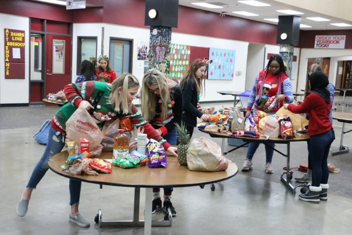 BATTLE GROUND: Students sort items for its Winter Wishes week of giving. Each December, Battle Ground schools host a variety of activities and events that support and engage families and inspire students to focus on community.