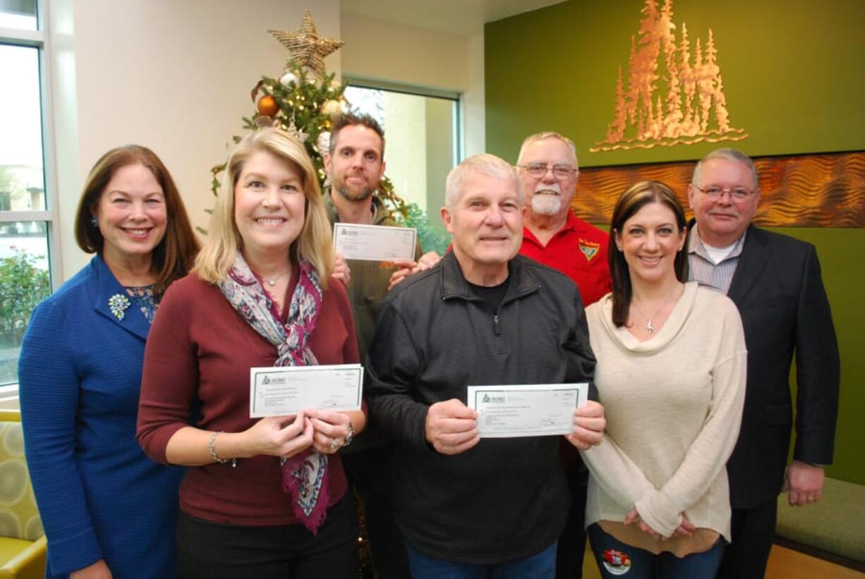 CENTRAL VANCOUVER: Pictured from left to right are Columbia Credit Union SVP Chief Marketing Officer Colleen Boccia; Returning Veterans Project Executive Director Bethany Walmsley; Home with Heroes board member Tom Horn; Community Military Appreciation Committee Co-Chairman Larry Smith; CMAC representative Jerry Keen; Columbia Credit Union Community Outreach Representative Teresa Wheeler; and Columbia Credit Union President and CEO Steve Kenny.