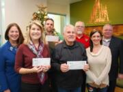 CENTRAL VANCOUVER: Pictured from left to right are Columbia Credit Union SVP Chief Marketing Officer Colleen Boccia; Returning Veterans Project Executive Director Bethany Walmsley; Home with Heroes board member Tom Horn; Community Military Appreciation Committee Co-Chairman Larry Smith; CMAC representative Jerry Keen; Columbia Credit Union Community Outreach Representative Teresa Wheeler; and Columbia Credit Union President and CEO Steve Kenny.