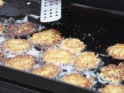 Potato latkes cook on a grill at Congregation Kol Ami. The congregation&#039;s men&#039;s club cooked the potato pancakes for the annual Latke Fest, a potluck held during Hanukkah.