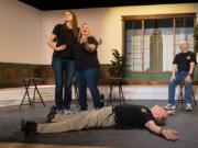 Comedy improvisers Brooke Chamberlain, left, Katie Skinner and Tony Provenzola don&#039;t seem a bit concerned that Martin Slagle is spread-eagled on the floor during a recent show by Magenta Improv Theater.