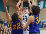 Skyview's Kyle Gruhler makes a game-clinching floater late in the fourth quarter over Columbia River's Marc Miranda (22) and Dylan Valdez (34).