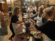 Guests Tarra Bathurst, clockwise from left, Brittany Georgiou and Sarah Schlichte clink their wine glasses during a dinner instruction course titled, &quot;Steakhouse DIY&quot; at the Chopping Block in Chicago. (John J.