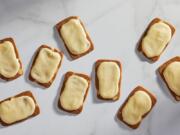 Thin almond cookies spread with a thick mango glaze.