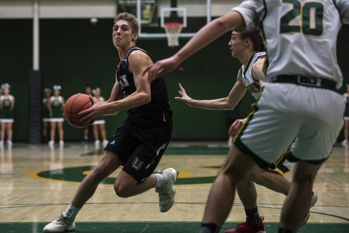 Union&#039;s Tanner Toolson drives against Evergreen on Wednesday night.