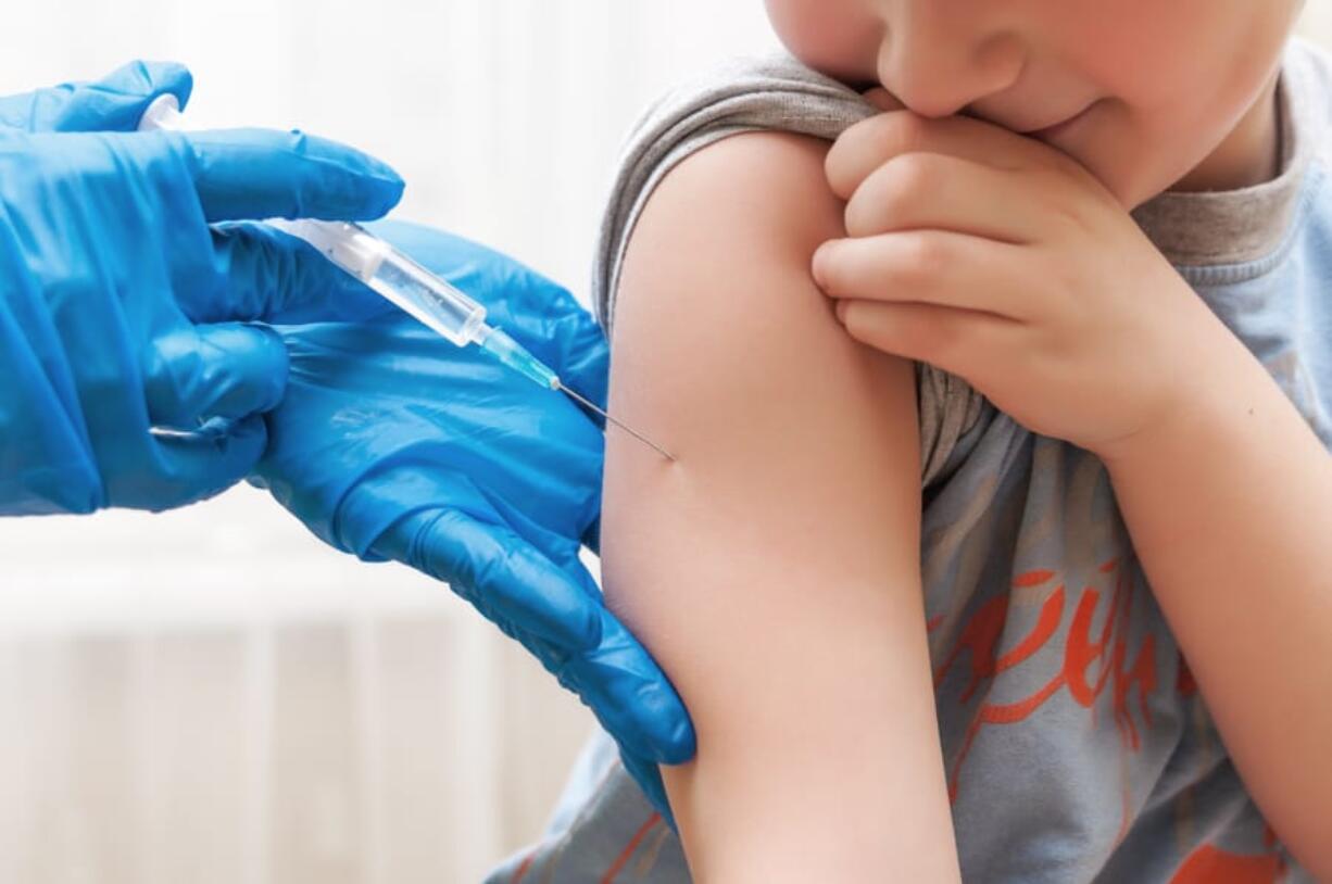 A boy gets a vaccination.