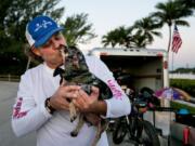 Jay Hamm, prepares to leave on a trip across the U.S. with his two dogs, including K Poppy here, to raise awareness about pet therapy, in Jupiter, Fla., on Nov. 1.