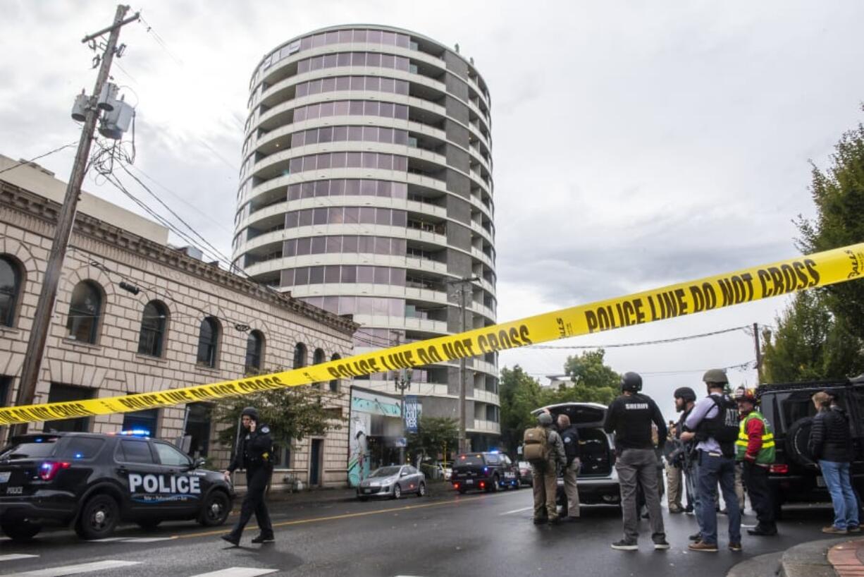 Law enforcement agencies strategize at the base of Smith Tower during an active shooter situation in Vancouver on Oct. 3.