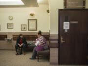 Kate Dunphy, left, deputy director of the Tenants Union of Washington, works with Charmaine Crossley following a hearing in her eviction case at Clark County Courthouse in October 2017.