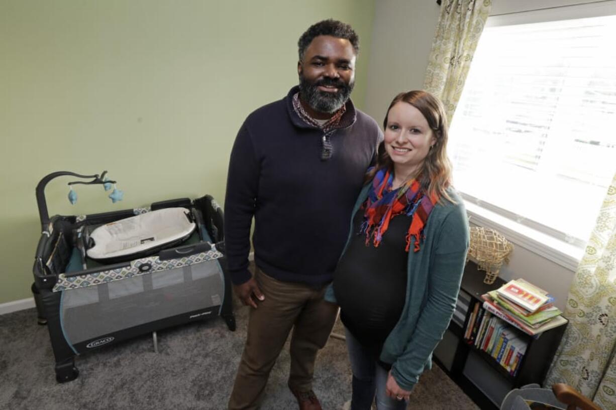 Kate and Quantas Ginn pose for a photo Sunday, Dec. 29, 2019 in their home in Tacoma, Wash., in the bedroom they are preparing ahead of the upcoming birth of their baby in late January. Kate Ginn is planning to submit paperwork on Thursday, Jan. 2, 2020 to apply for paid time off from her job as a project manager for a non-profit organization under Washington state&#039;s new paid family leave law. (AP Photo/Ted S. Warren) (Ted S.