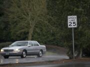 A vehicle travels westbound on McGillivray Boulevard just east of 136th Avenue in 2014. In the summer of 2020 the intersection will see upgrades designed to improve pedestrian safety, including new crosswalk striping and signage as part of Vancouver&#039;s Neighborhood Traffic Calming Program.