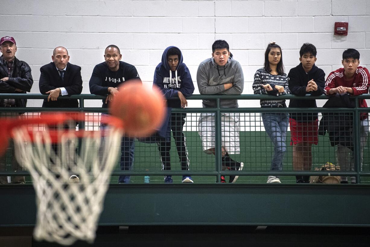 Spectators watch as a ball bounces off Union’s hoop during a game between Evergreen and Union at Evergreen High School on Wednesday night, Dec. 17, 2019.