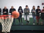 Spectators watch as a ball bounces off Union’s hoop during a game between Evergreen and Union at Evergreen High School on Wednesday night, Dec. 17, 2019.