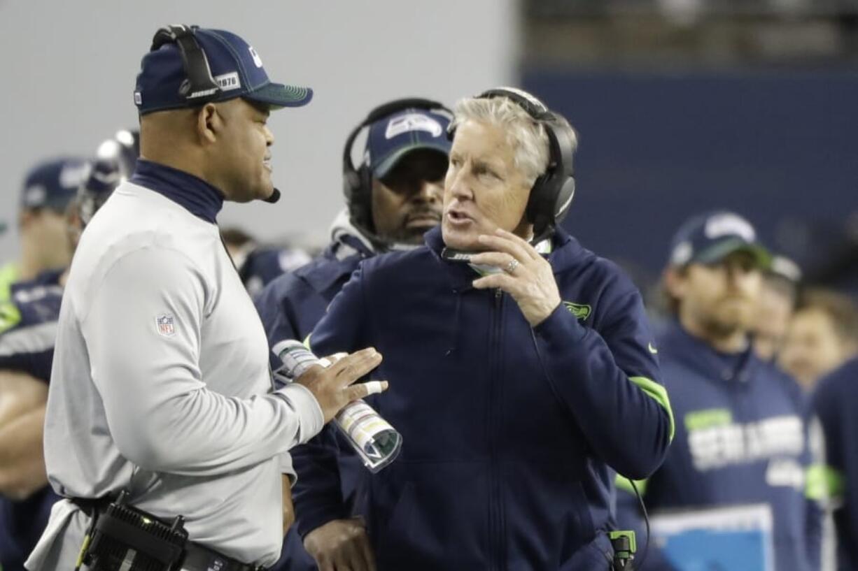 Seattle Seahawks head coach Pete Carroll, right, has taken criticism for his team&#039;s clock management late in Sunday&#039;s game against the San Francisco 49ers, including a crucial delay of game penalty. (Ted S.