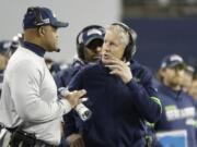 Seattle Seahawks head coach Pete Carroll, right, has taken criticism for his team&#039;s clock management late in Sunday&#039;s game against the San Francisco 49ers, including a crucial delay of game penalty. (Ted S.