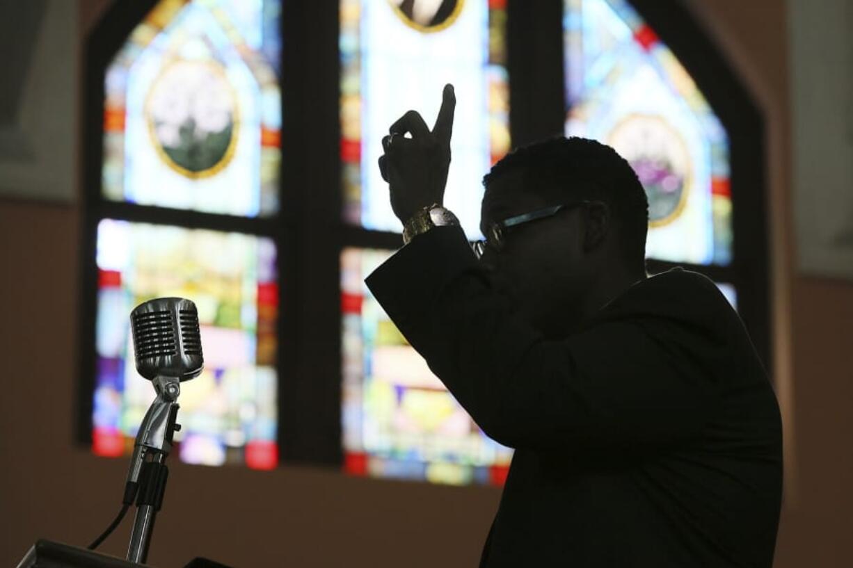 FILE - In this Wednesday, Aug. 28, 2013 file photo, Rev. Shanan Jones delivers a sermon at Ebenezer Baptist Church in Atlanta. According a study released on Monday, Dec. 16, 2019 by the Pew Research Center, the median length of U.S. sermons in April and May was 37 minutes. Catholic sermons were the shortest, at a median of just 14 minutes, compared with 25 minutes for sermons in mainline Protestant congregations and 39 minutes in evangelical Protestant congregations. Historically black Protestant churches had by far the longest sermons, at a median of 54 minutes.