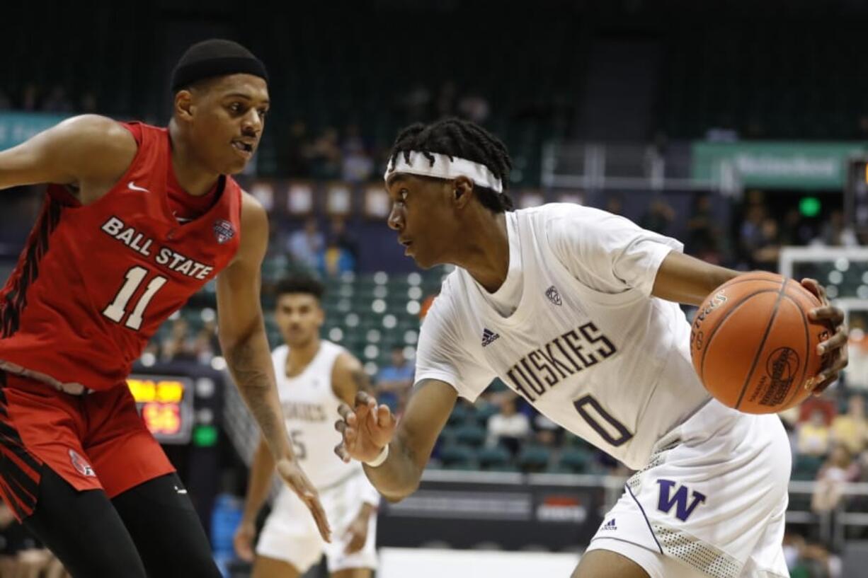 Washington forward Jayden McDaniels (0) goes toward the basket against Ball State guard Jarron Coleman (11) during the second half of an NCAA college basketball game, Sunday, Dec. 22, 2019, in Honolulu.