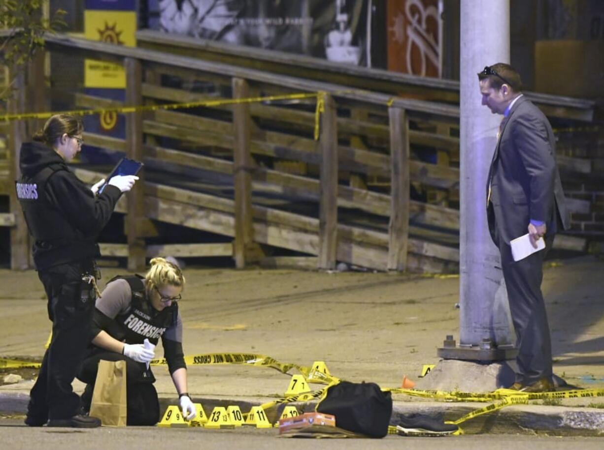 FILE - In this Sunday, April 28, 2019 file photo, Police work near the scene where authorities say several people were shot, at least one fatally in Baltimore. Baltimore broke its annual per capita homicide record after reaching 342 killings Friday, Dec. 27, 2019. With just over 600,000 residents, the city hit a historically high homicide rate of about 57 per 100,000 people after a week of relentless gunfire saw eight people shot three fatally in one day and nine others one fatally another day.