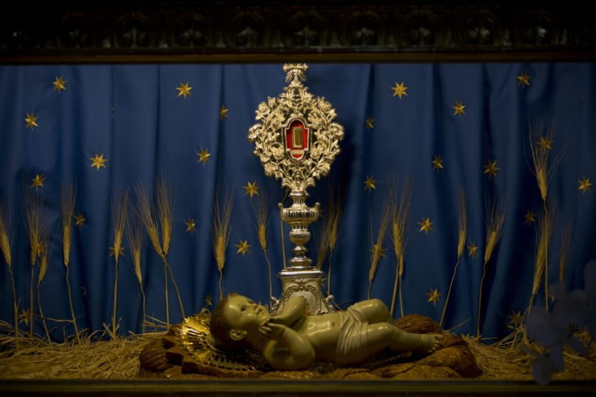 In this Thursday, Dec. 5, 2019, photo, a wooden figure is displayed in the Church of the Nativity, traditionally believed by Christians to be the birthplace of Jesus Christ, in the West Bank city of Bethlehem. As visitors descend on Bethlehem this Christmas, they have the option of staying in restored centuries-old guesthouses, taking food tours of local markets, and perusing the dystopian art in and around a hotel designed by the British graffiti artist Banksy.