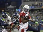 Arizona Cardinals running back Kenyan Drake gets past Seattle Seahawks outside linebacker K.J. Wright, center, to rush for a touchdown during the second half of an NFL football game, Sunday, Dec. 22, 2019, in Seattle.