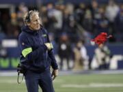 Seattle Seahawks head coach Pete Carroll throws a challenge flag near the end of an NFL football game against the Arizona Cardinals, Sunday, Dec. 22, 2019, in Seattle.