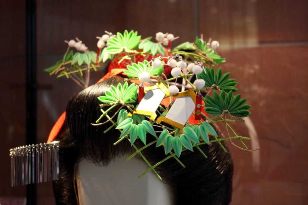 This undated photo shows a tsumami kanzashi hair ornament made by Kuniko Kanawa of Atelier Kanawa, a professional Edo Tsumami Kanzashi artisan. The craft of making traditional tsumami kanzashi hair ornaments has been passed on from master to apprentice for generations, but today crafters and hobbyists have also adopted its basic method of making folded fabric flowers.