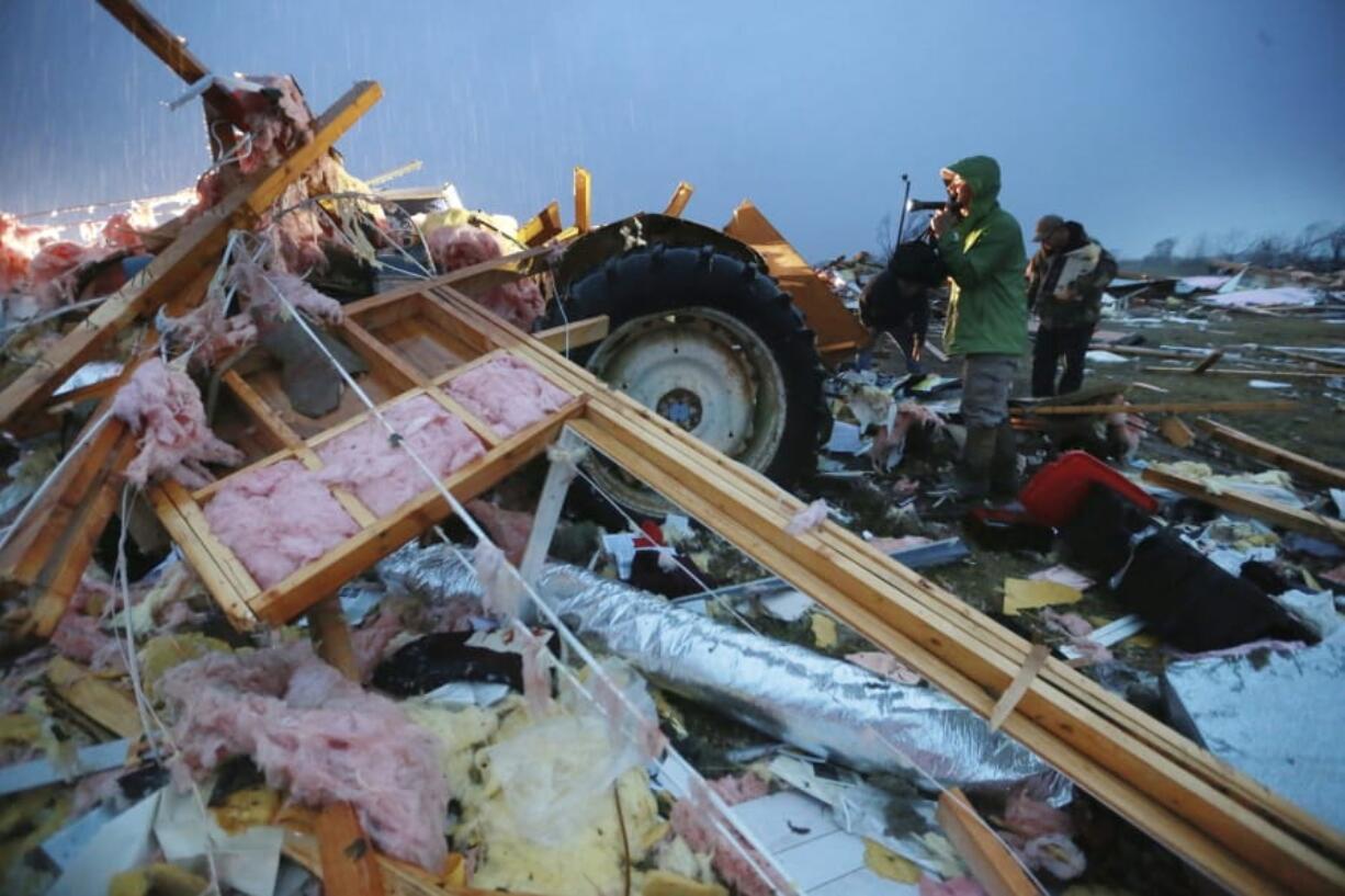 Shane Keith and other volunteers help search debris and try to salvage what they can from their church that was completely destroyed in a tornado that touched down in Guntown, Miss., Monday, Dec. 16, 2019.