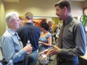 Paul Dennis, former president and CEO of the Camas-Washougal Economic Development Association, right, talks with former Port of Camas-Washougal Commissioner Bill Macrae-Smith in 2015.