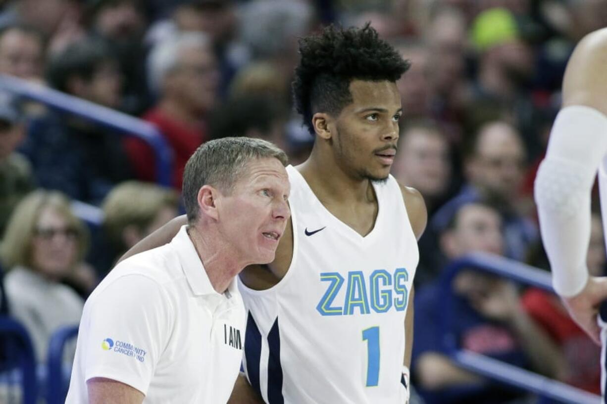 Gonzaga head coach Mark Few, left, speaks with guard Admon Gilder (1) during the second half of an NCAA college basketball game against Eastern Washington in Spokane, Wash., Saturday, Dec. 21, 2019. Gonzaga won 112-77.