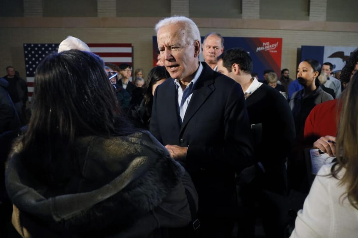 Democratic presidential candidate former Vice President Joe Biden greets audience members during a bus tour stop, Tuesday, Dec. 3, 2019, in Mason City, Iowa.