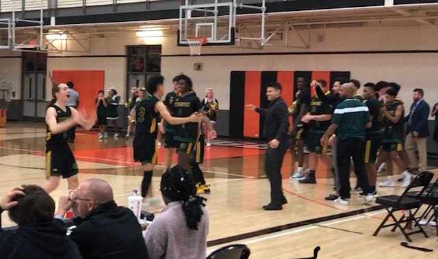 Evergreen's Jaden Stanley yells to the crowd after the Plainsmen's 59-51 win over Battle Ground on Monday.