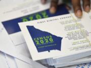 FILE - In this Aug. 13, 2019, file photo a worker gets ready to pass out instructions in how fill out the 2020 census during a town hall meeting in Lithonia, Ga. Facebook says it won&#039;t allow interference with the U.S. census on its platform, including posting misleading information about when and how to participate, who can participate and the consequences of taking part.