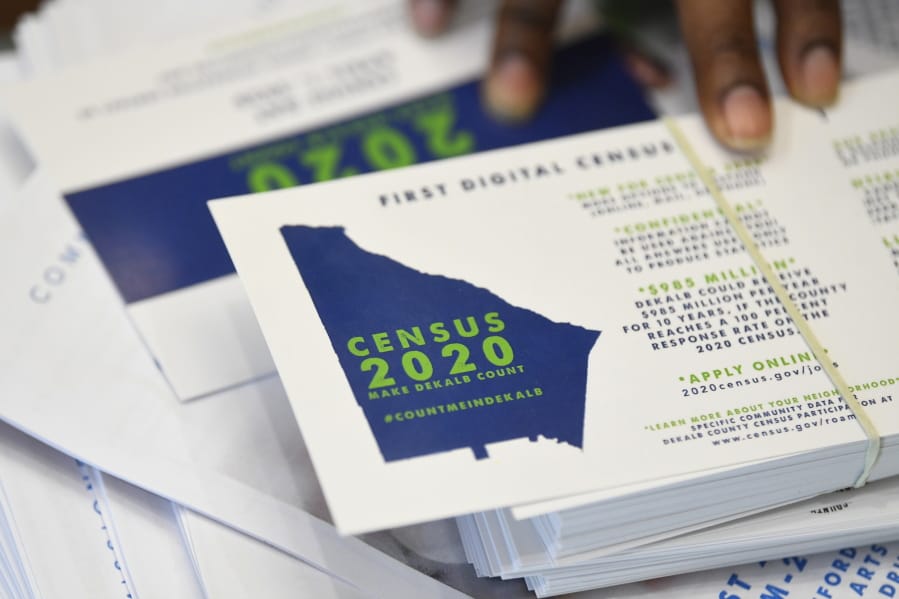 FILE - In this Aug. 13, 2019, file photo a worker gets ready to pass out instructions in how fill out the 2020 census during a town hall meeting in Lithonia, Ga. Facebook says it won&#039;t allow interference with the U.S. census on its platform, including posting misleading information about when and how to participate, who can participate and the consequences of taking part.