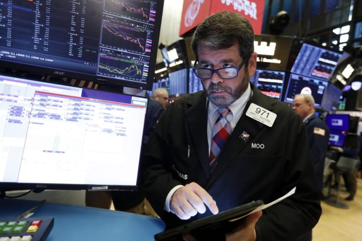 FILE - In this Dec. 5, 2019, file photo trader James MacGilvray works on the floor of the New York Stock Exchange. The U.S. stock market opens at 9:30 a.m. EST on Monday, Dec. 30.