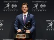 NCAA college football player, LSU quarterback Joe Burrow poses for a photo after winning the Heisman Trophy, Saturday, Dec. 14, 2019, in New York.